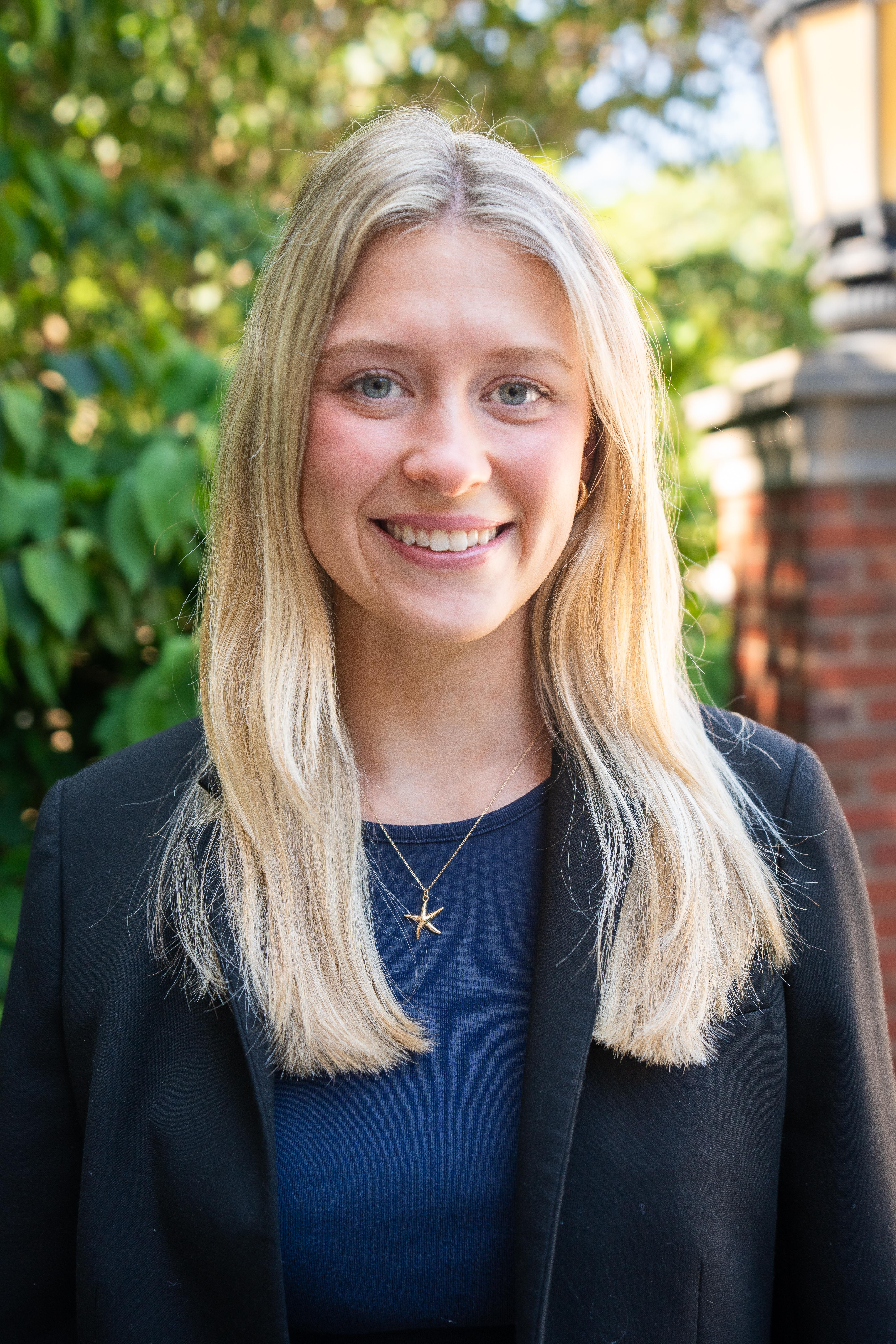 a portrait of Lauren in front of greenery