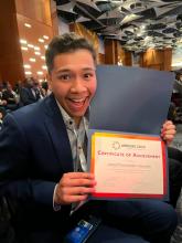 Alex  is showing his award for best talk prize.  I