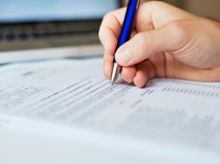 Close up of a hand writing an application