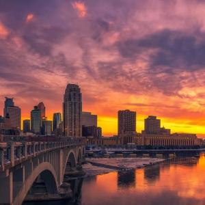 Minneapolis skyline and the Stone Arch Bridge at sunset