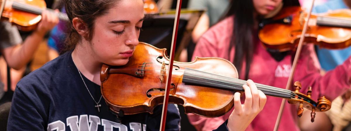 String students rehearsing with CWRU sweaters
