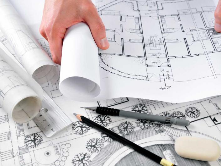Person reviewing architectural designs