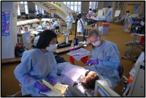 Two dentists inspecting a child