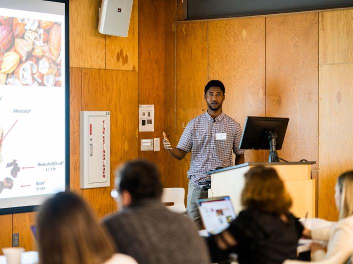 A professor lecturing at the front of a class.