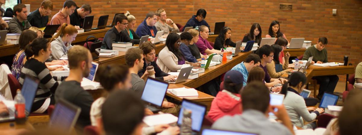 law students with laptops in a circular theater classroom
