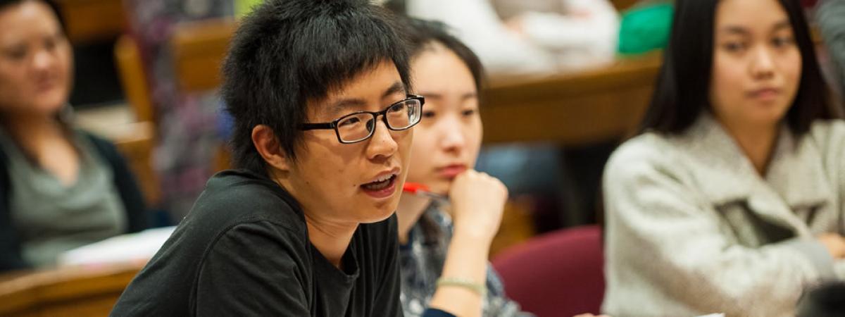 law student speaking in class, with other students in background