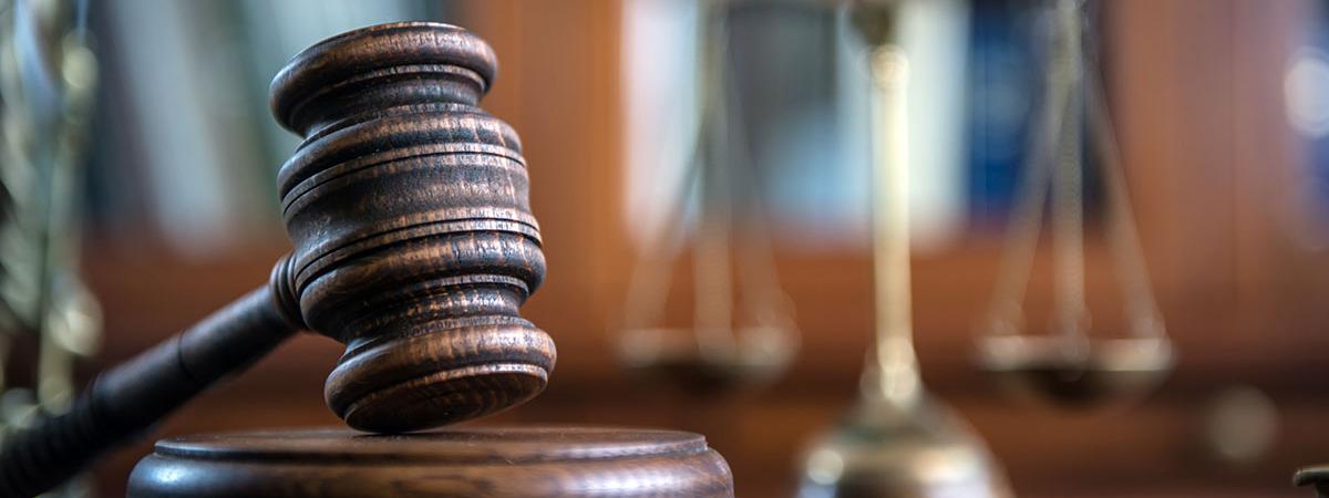 A law gavel resting on a desk