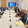 Urban Development Lab 2022 cohort pictured sitting around a table with Matthew Rossman