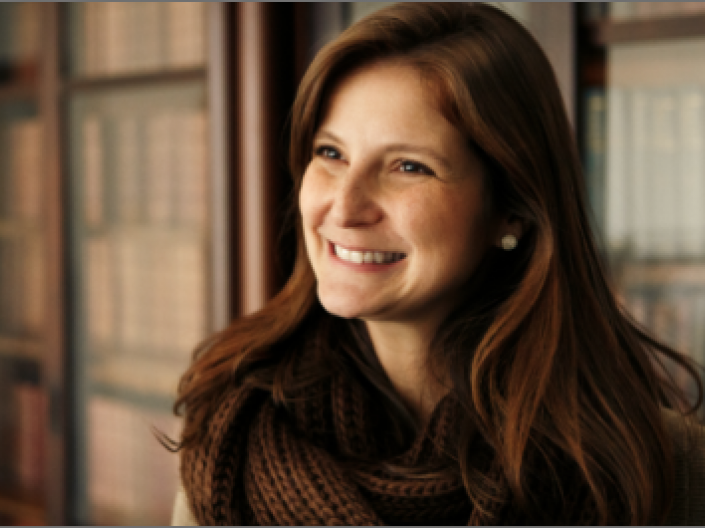 CWRU SJD Law student in front of books in the law library