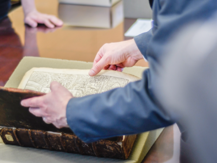 Close up of library users viewing special collection material at KSL