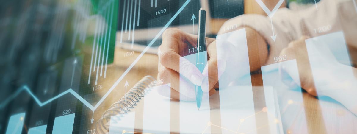 Woman writing while overlayed graph show uptick