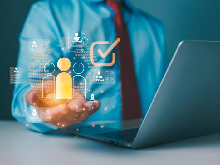 Person holding resources at a computer