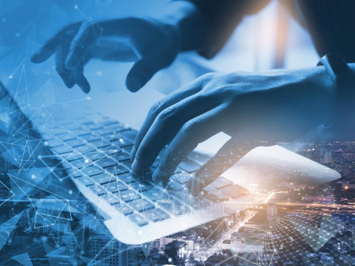 Hands typing on a computer