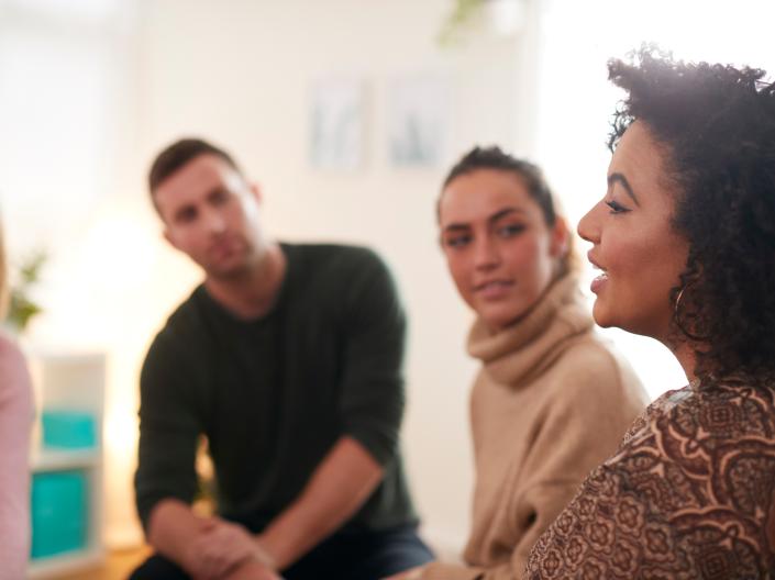 Woman talking to a group of people