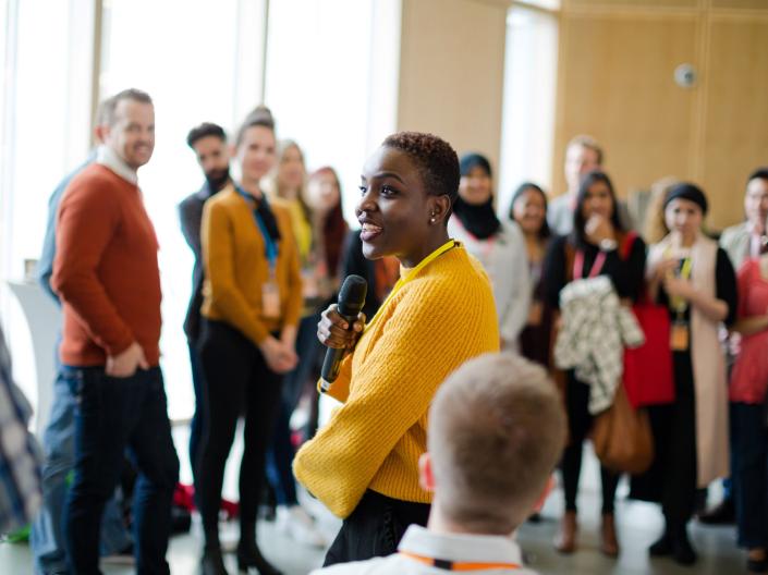 Woman talking to group of people