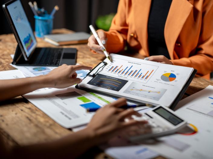 Woman Pointing to Graphs