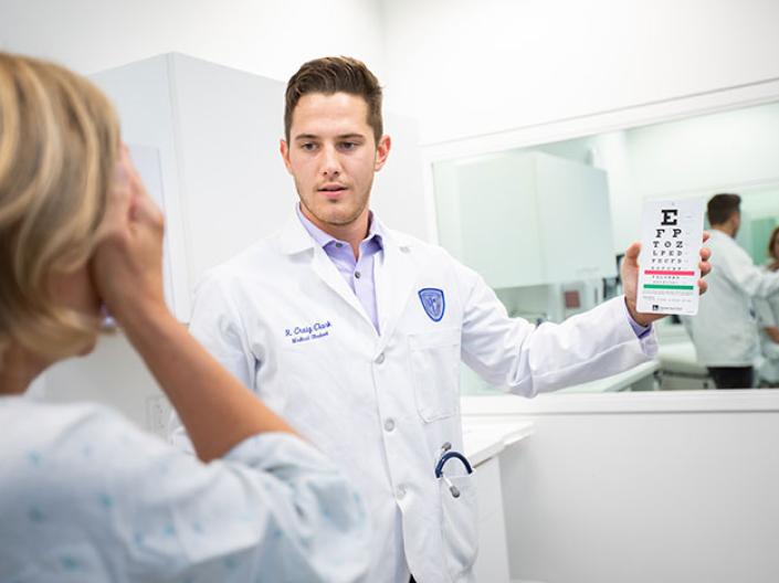 A medical student doing an eye exam