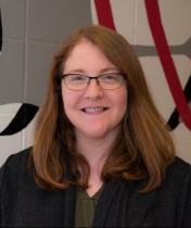 Woman with red hair and glasses