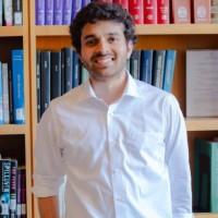 Man with dark hair and white shirt