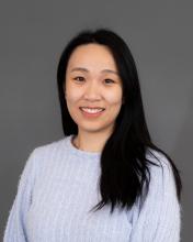 Woman with dark hair and a light sweater