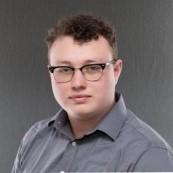 Man with glasses in gray shirt