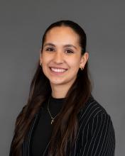 Woman with long dark hair and dark shirt