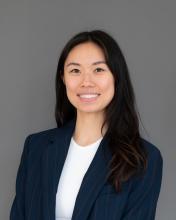 Woman with dark hair wearing a dark blue jacket