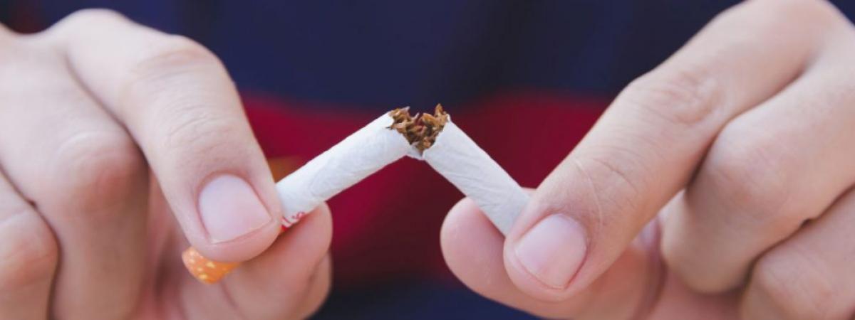 hands breaking a cigarette in half