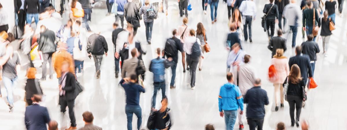 Many people moving through a large space