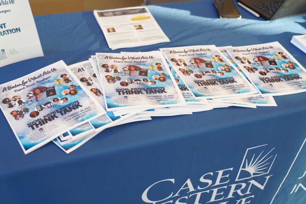 Photo of a table with programs from the Social Justice Institute Think Tank event in 2022