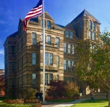 Adelbert Hall with flag flying in front.