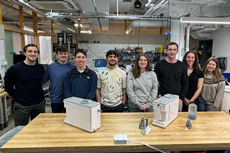 Students at CWRU standing behind the CLEANR filtration system
