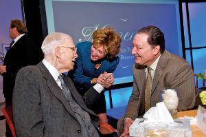 Barabara R. Snyder shakes Tinkham Veale II's hand, standing next to Ronn Richard