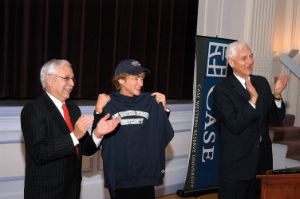 President Snyder stands next to CWRU trustees, wearing university paraphernalia