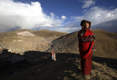 A Buddhist nun enjoys the fresh air outside the Serthar Wuming Buddhist Study Institute (elevation: 12,100 feet) in Tibet.