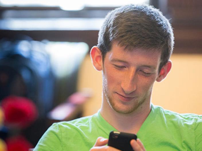 Case Western Reserve University male student looking at his smartphone