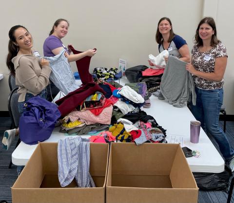 Volunteers sort clothing at a table