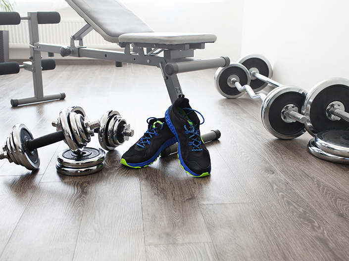 Photo of weights and a workout bench in a gym