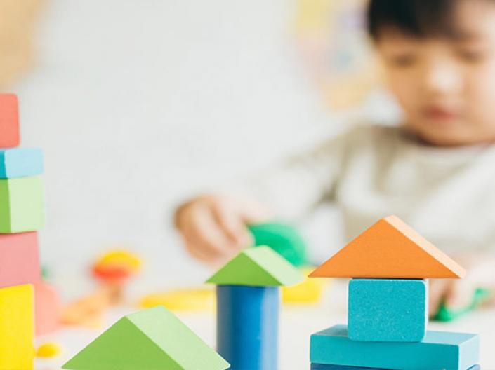 Child playing with colorful blocks