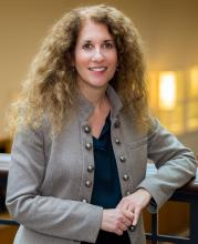 Lisa Palazzo posing for a photo inside Adelbert Hall staircase.