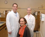 Picture of three dentists standing together in an office.