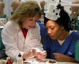 A student and teacher looking at teeth