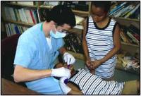 Man inspecting a child's teeth.