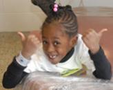 Black girl smiling and giving double thumbs up