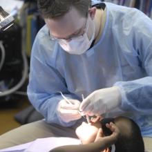 Dentist inspecting a child