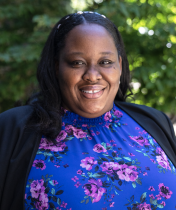 Black woman in front of trees