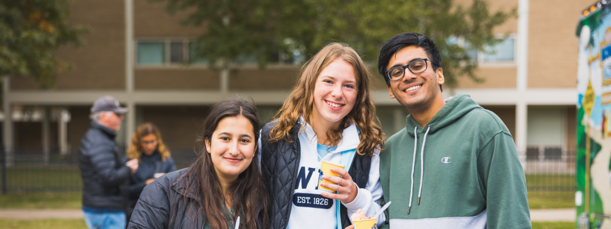 Three happy students posing for an image outside at Case Western Reserve University