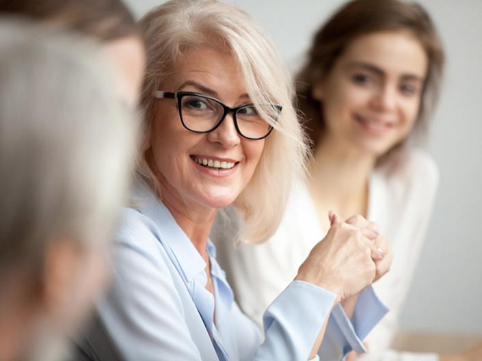 Woman smiling with her peers.