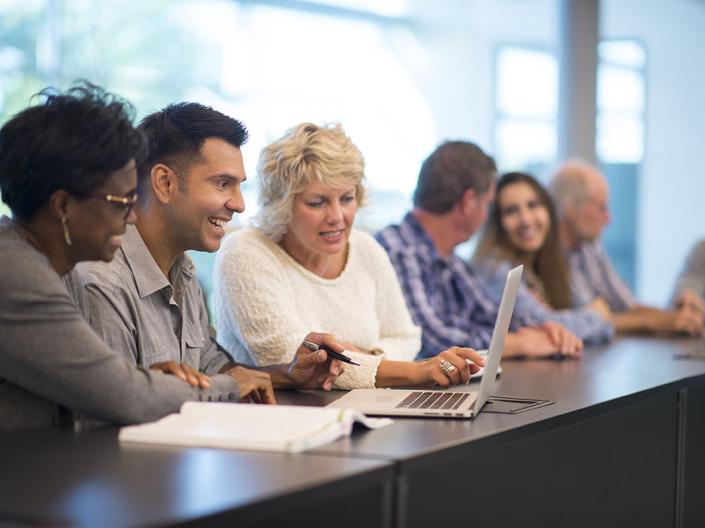 Group of faculty and staff members working together