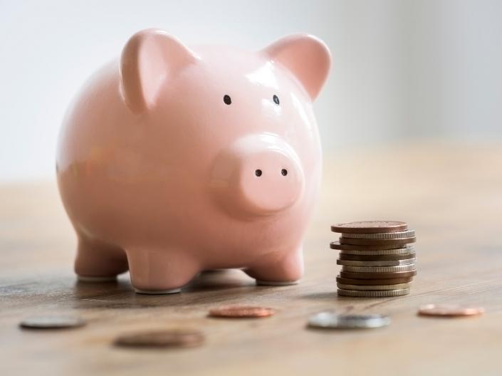 A piggy bank with a stack of coins.